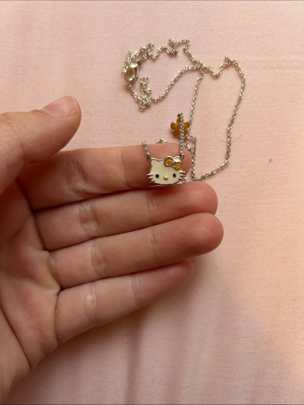 Hello Kitty Silver Necklace with White Enamel Face and Gold Flower Accent